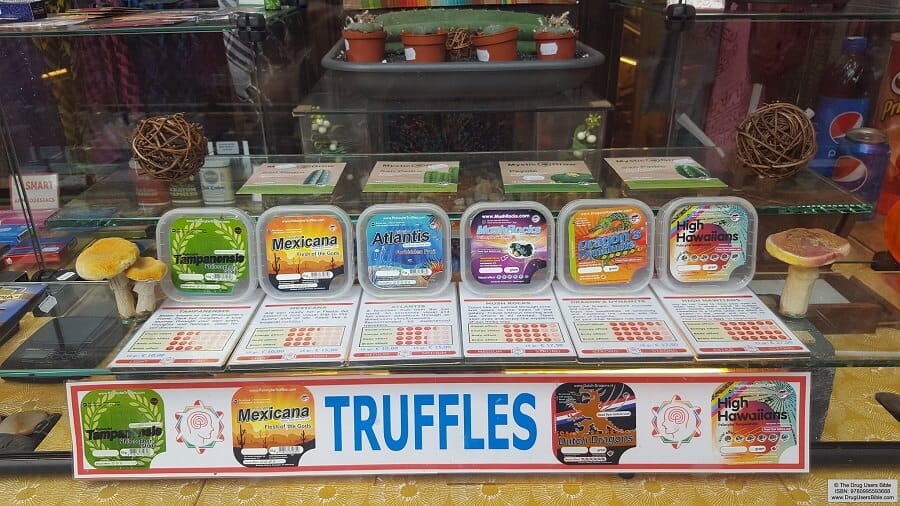 Store shelf showing packaged fresh magic truffles including Mexicana, Atlantis, and High Hawaiians strains in vacuum-sealed containers